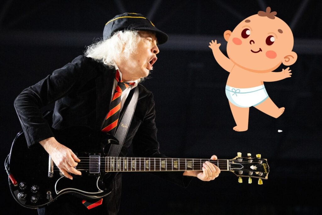 Angus Young firma un bebe en una tienda temporal en Toronto