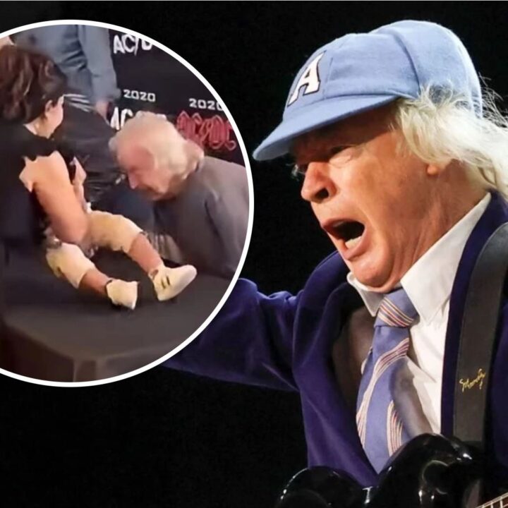 Angus Young firma un bebe de un fan en Toronto durante un evento sorpresa